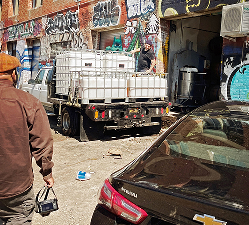 raj watching Adam move wine